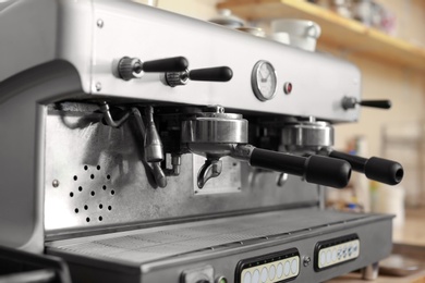 Photo of Modern electric coffee machine with portafilters, closeup