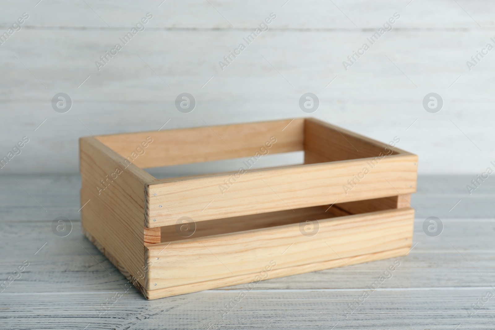 Photo of Wooden crate on table against light background. Space for text