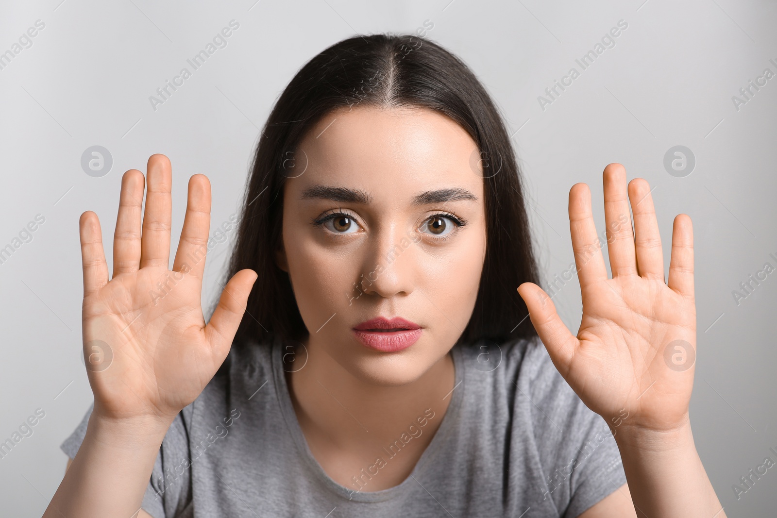 Photo of Young woman stuck to transparent screen. Internet addiction