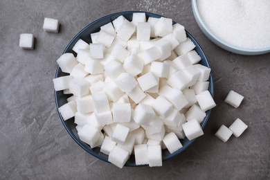 Photo of Flat lay composition with refined sugar cubes on black table, flat lay