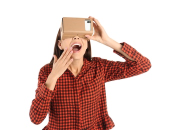 Photo of Young woman using cardboard virtual reality headset, isolated on white