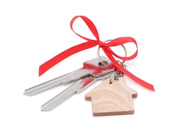 Keys with keychain in shape of house and red bow isolated on white