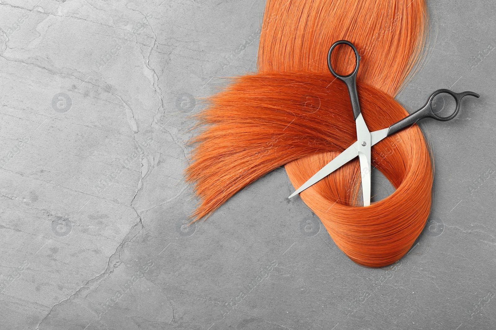 Photo of Flat lay composition with red hair, scissors and space for text on grey background. Hairdresser service