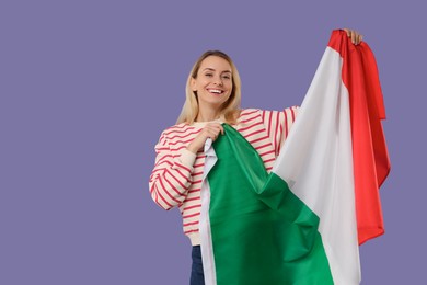 Happy woman with flag of Italy on violet background, space for text