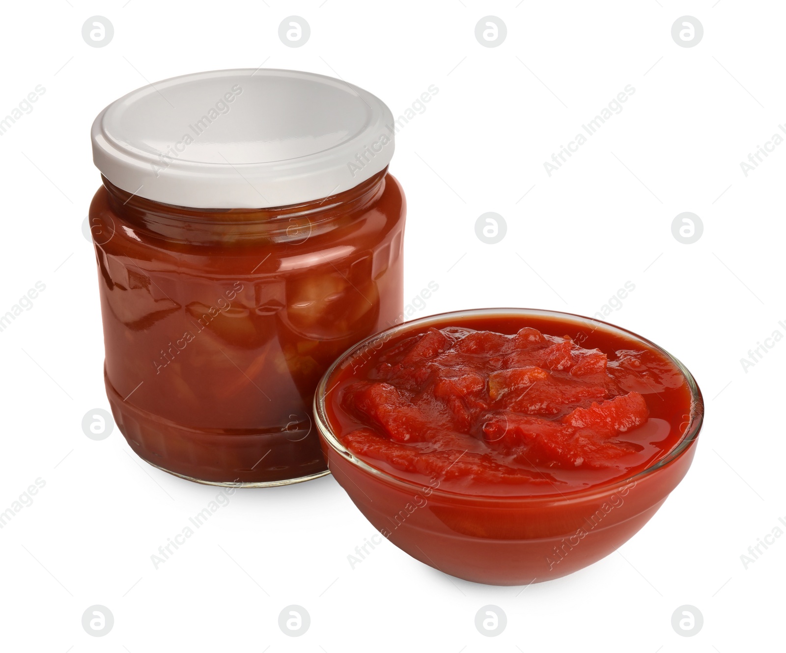 Photo of Glass jar and bowl of delicious lecho on white background