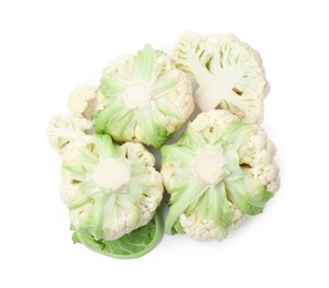 Cut and whole cauliflowers on white background, top view