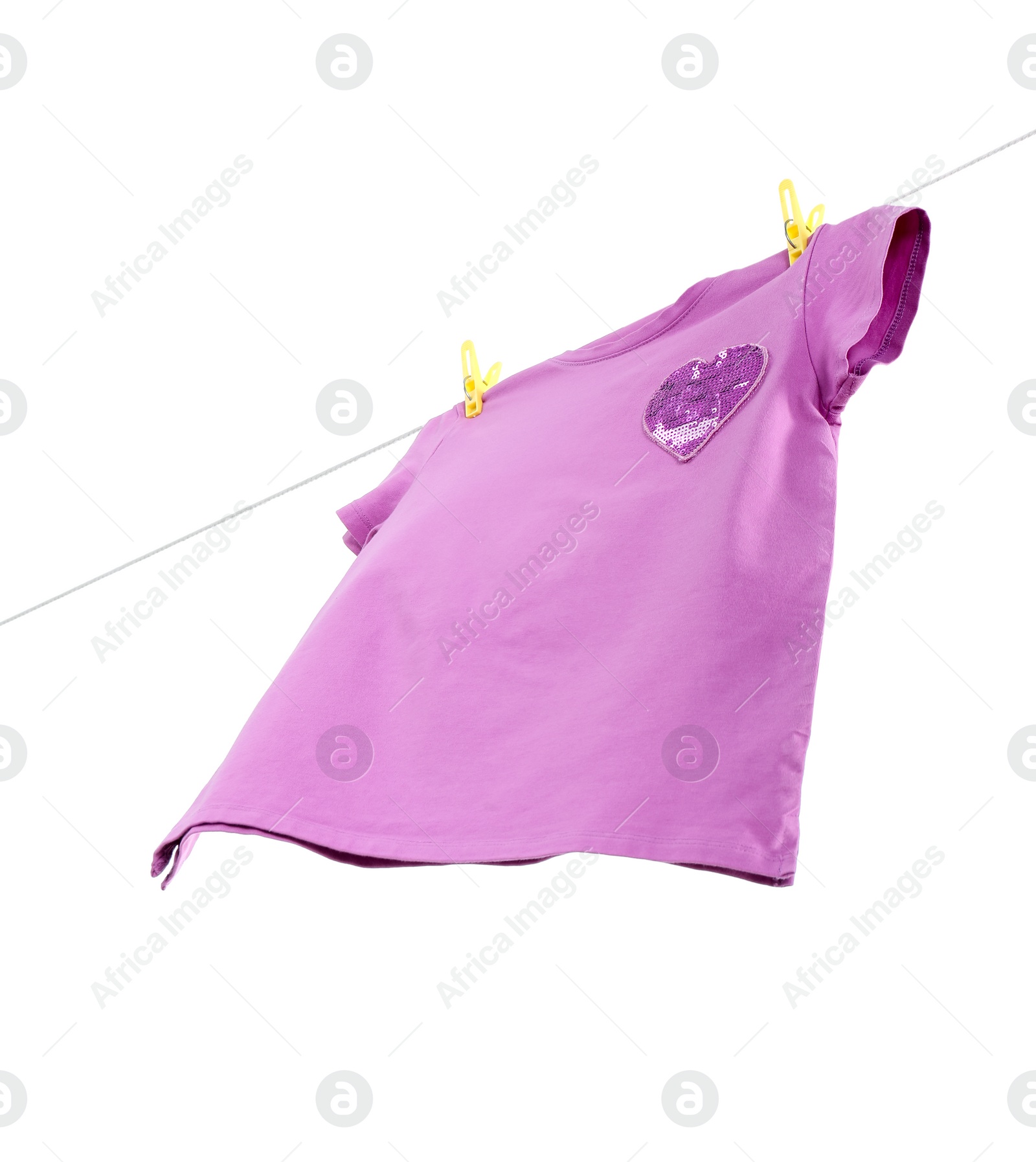 Photo of One violet t-shirt drying on washing line isolated on white