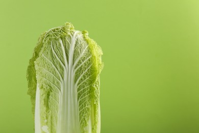 Fresh ripe Chinese cabbage on light green background, closeup. Space for text