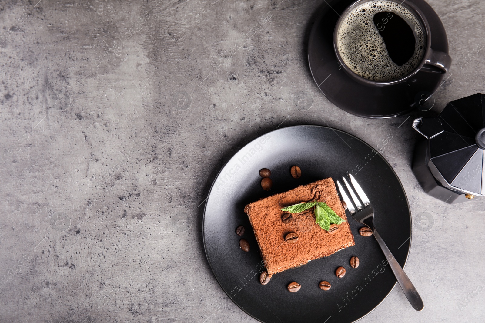 Photo of Flat lay composition with tiramisu cake and coffee on grey table, space for text