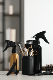 Photo of Set of hairdresser tools on table in salon