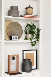 Photo of Shelves with different decor indoors. Interior design