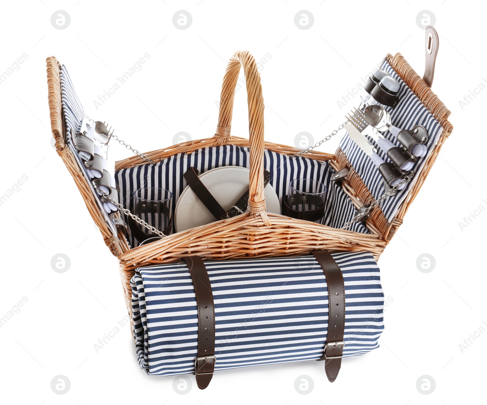 Photo of Wicker basket with picnic essentials and blanket on white background