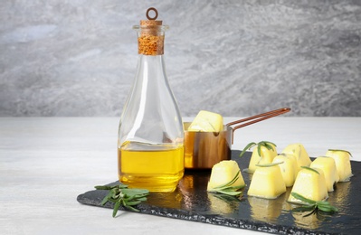 Composition with rosemary and olive oil ice cubes on table