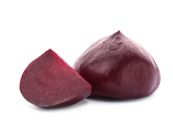 Cut and whole boiled beets on white background. Taproot vegetable