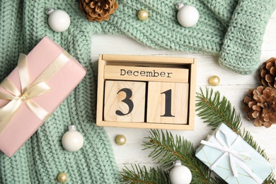 Flat lay composition with block calendar on white wooden table