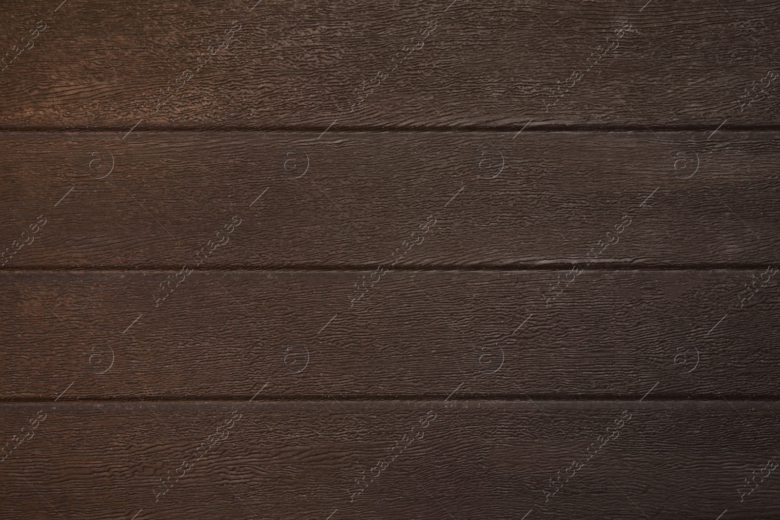 Photo of Texture of dark brown wooden surface as background