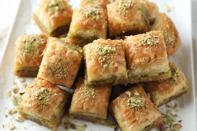 Photo of Delicious fresh baklava with chopped nuts on plate, closeup. Eastern sweets