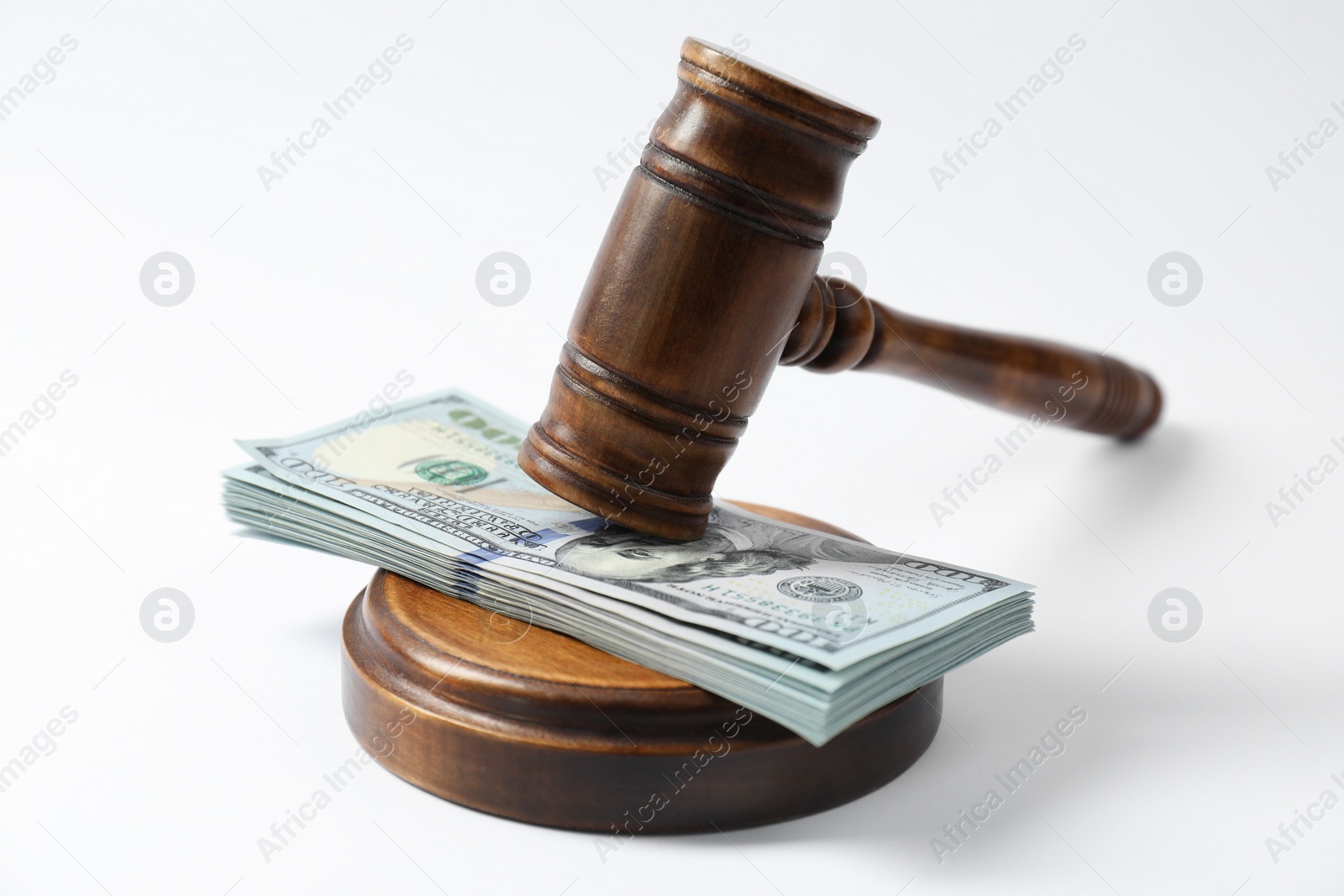 Photo of Law gavel with stack of dollars on white background