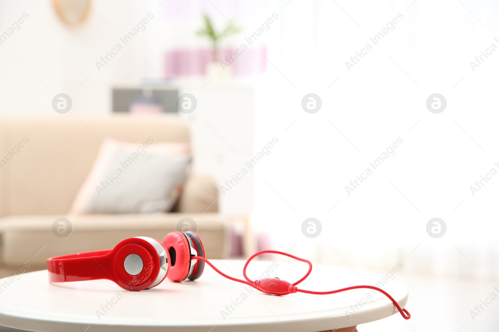 Photo of Stylish headphones on table indoors. Space for text