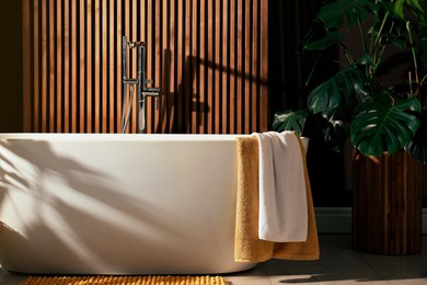 Cozy bathroom interior with stylish ceramic tub