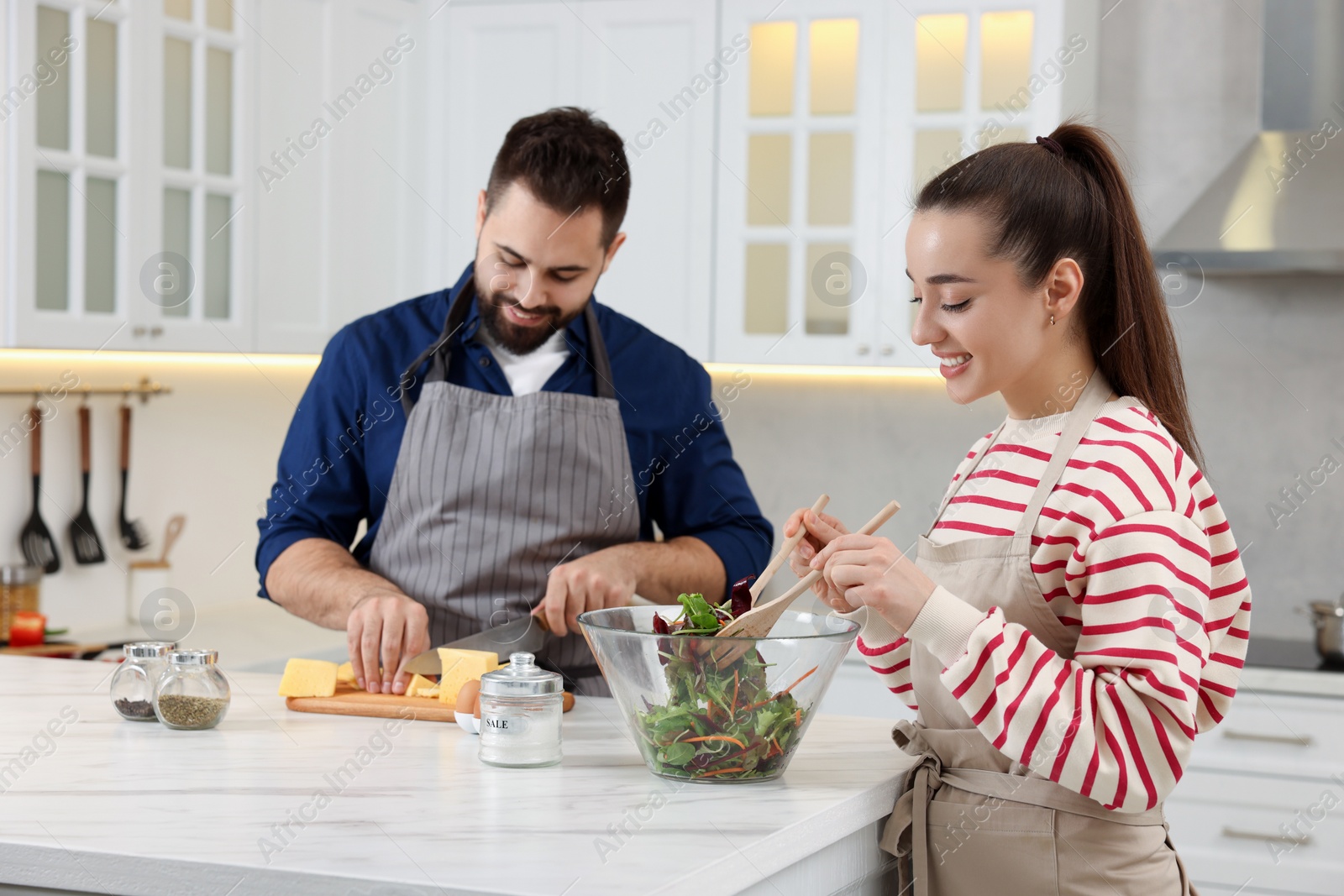 Photo of Happy lovely couple cooking together in kitchen