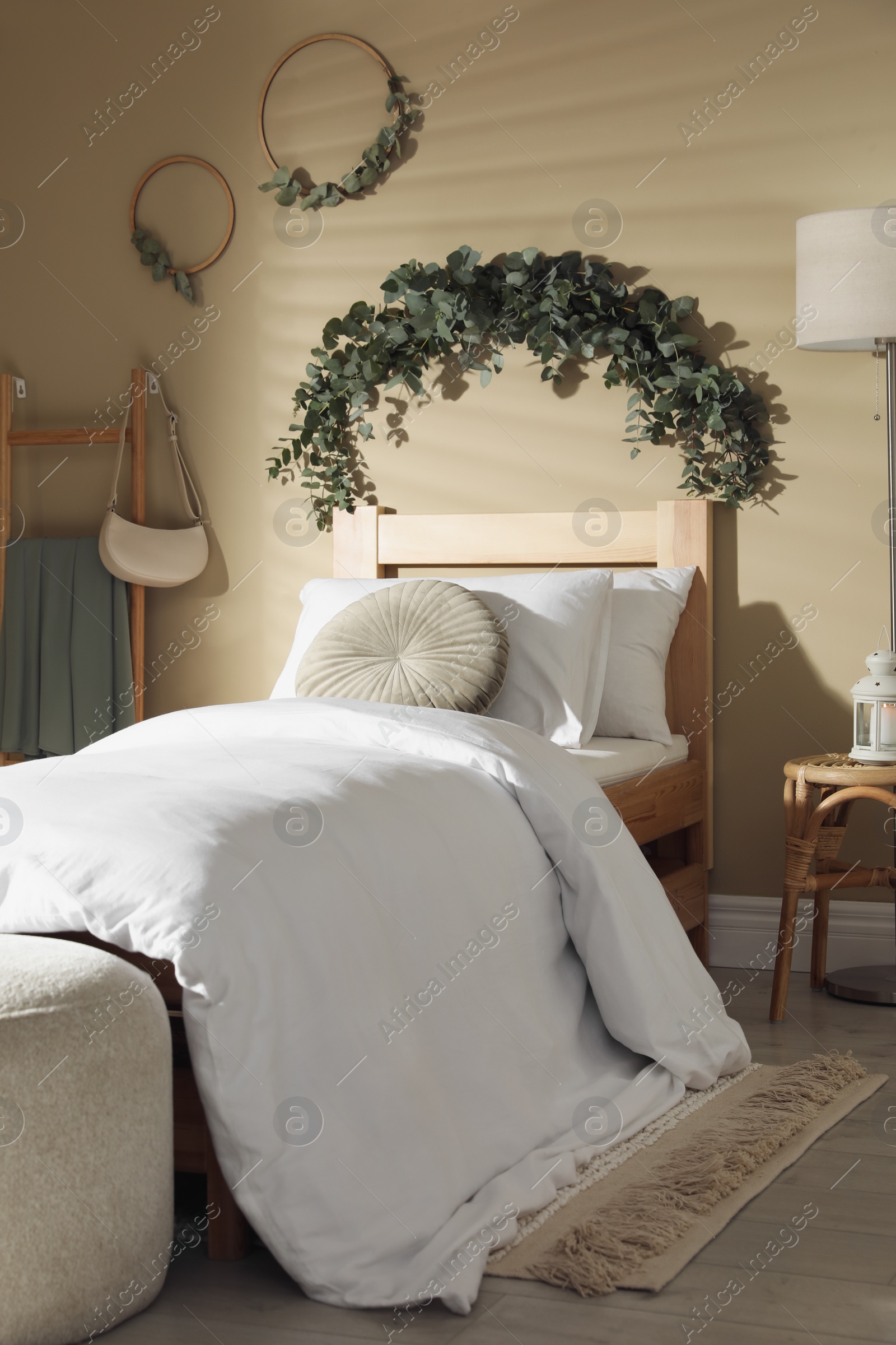 Photo of Stylish bedroom decorated with beautiful eucalyptus garland