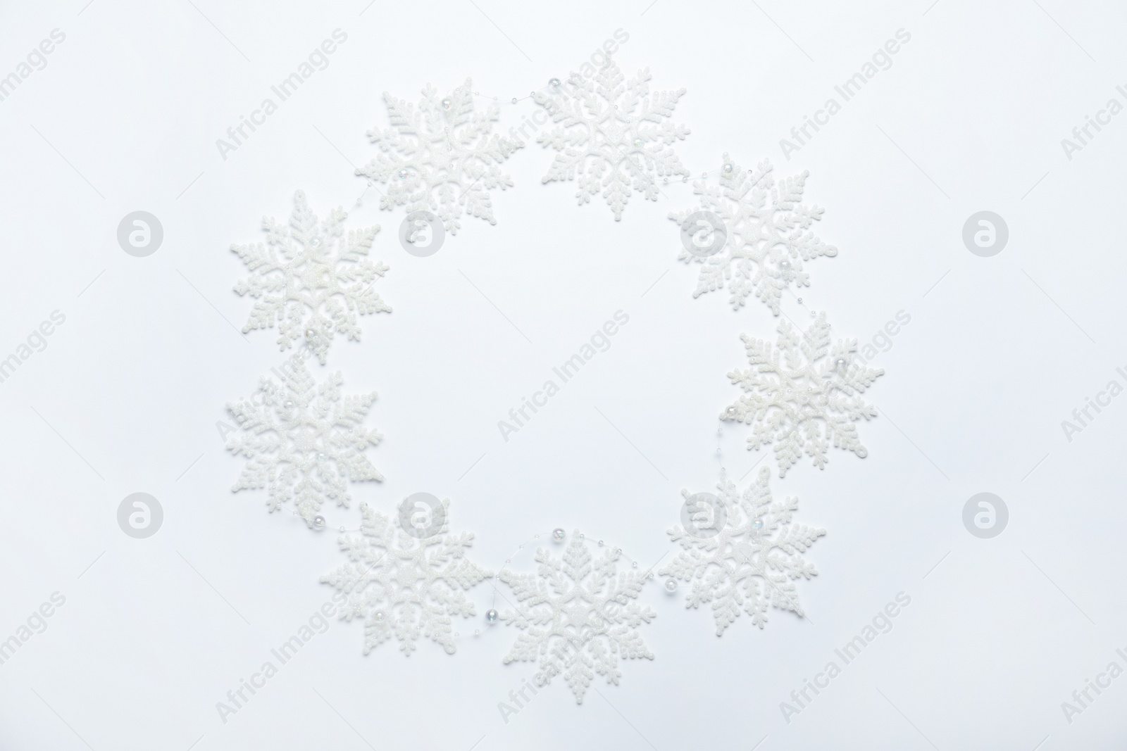 Photo of Beautiful decorative snowflakes on white background, flat lay. Space for text