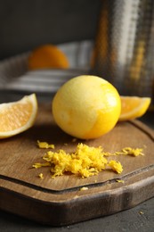 Lemon zest and fresh fruits on grey table, closeup