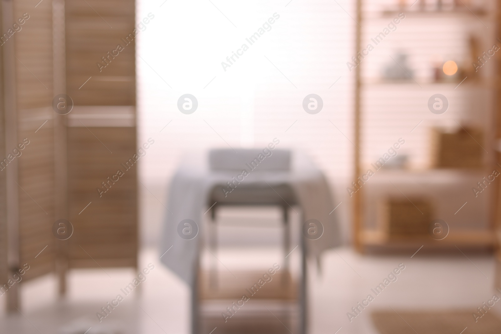 Photo of Cozy massage room with equipment, blurred view