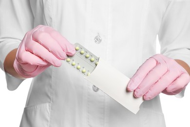 Photo of Doctor holding blister of oral contraception pills on white background, closeup