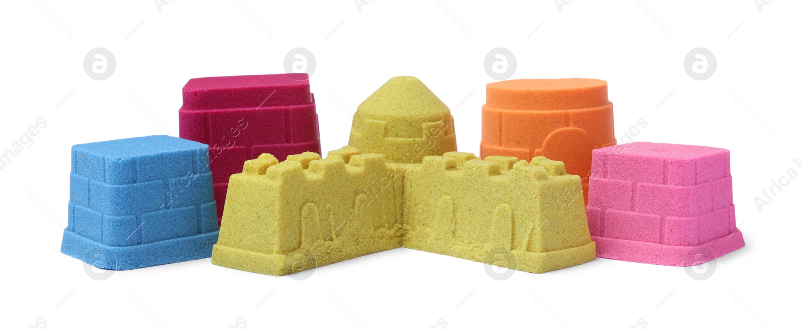 Photo of Different towers made of kinetic sand on white background