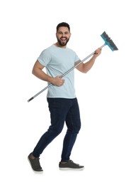 Young man with broom on white background