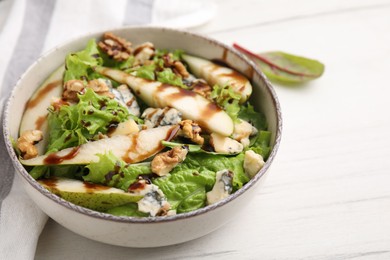 Photo of Delicious pear salad with sauce in bowl on light table, closeup. Space for text