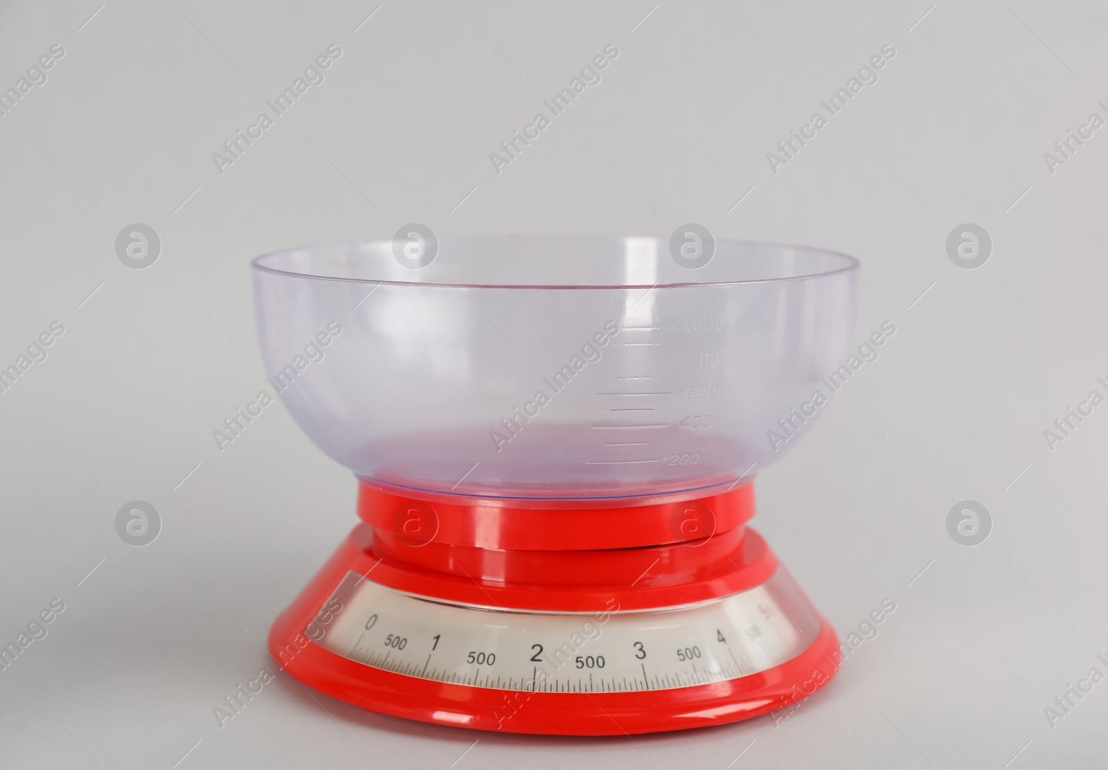 Photo of Kitchen scale with plastic bowl on light grey background