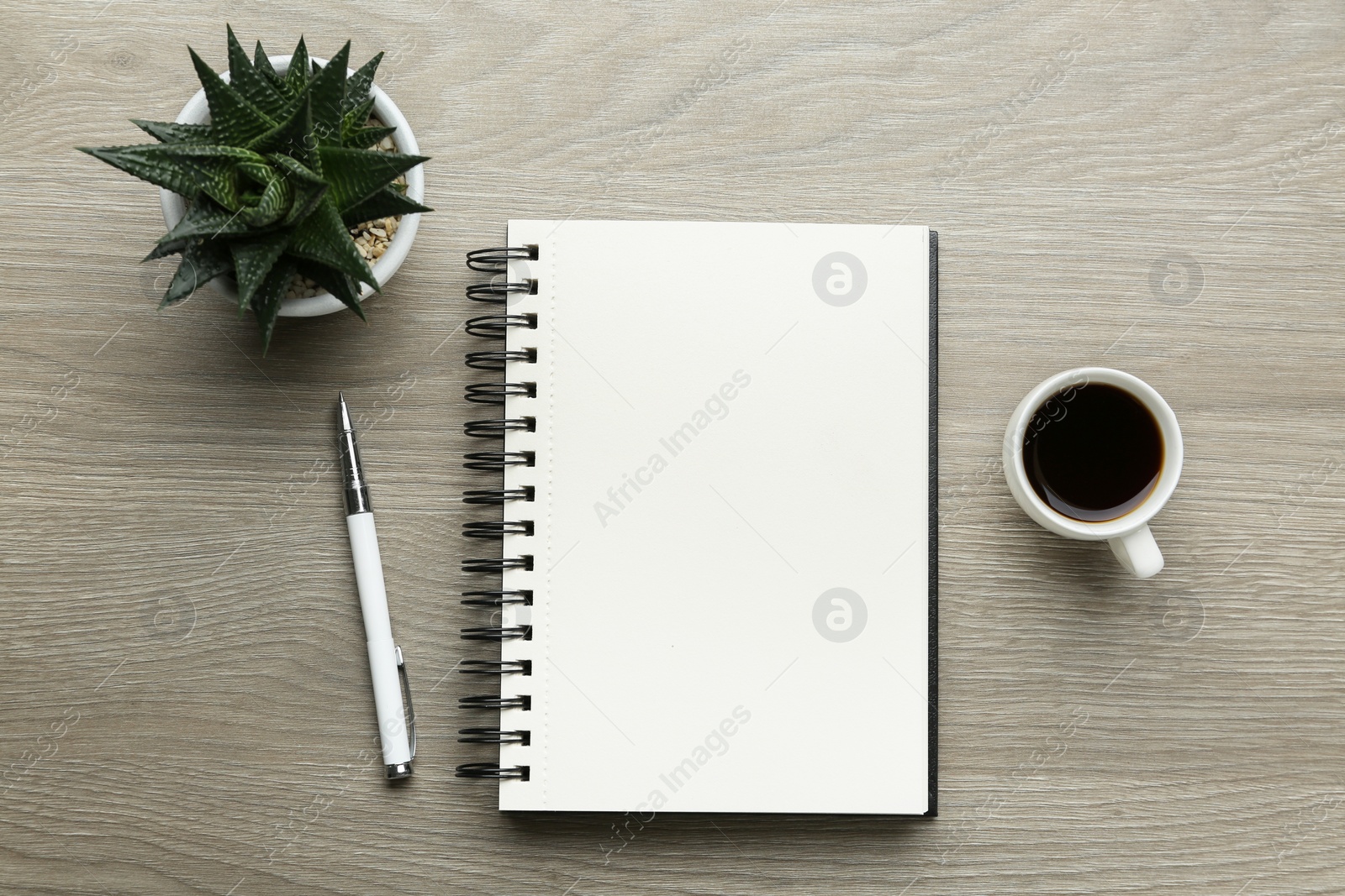 Photo of Flat lay composition with open notebook on light wooden table. Space for text