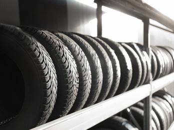 Photo of Tires on rack in car service workshop