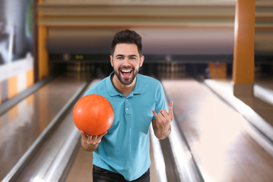 Photo of Young man with ball in bowling club