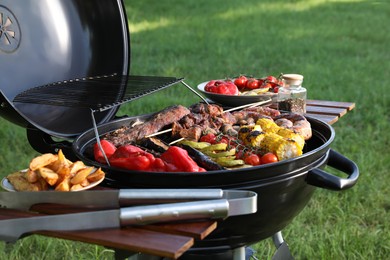 Tasty meat and vegetables on barbecue grill outdoors