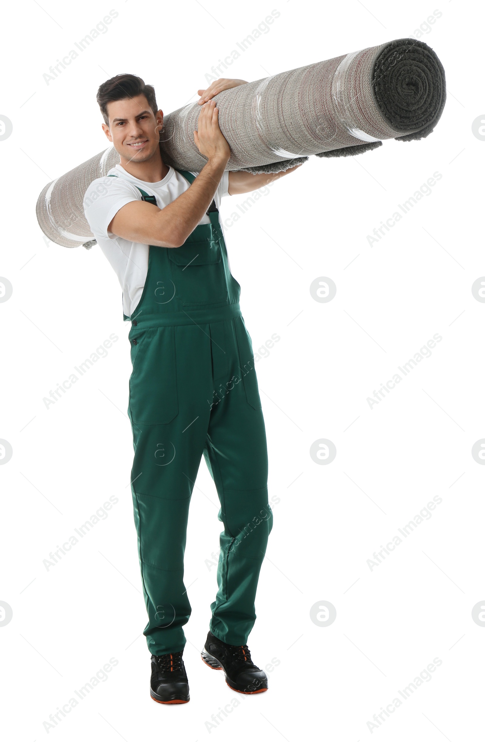 Photo of Male worker with rolled carpet on white background