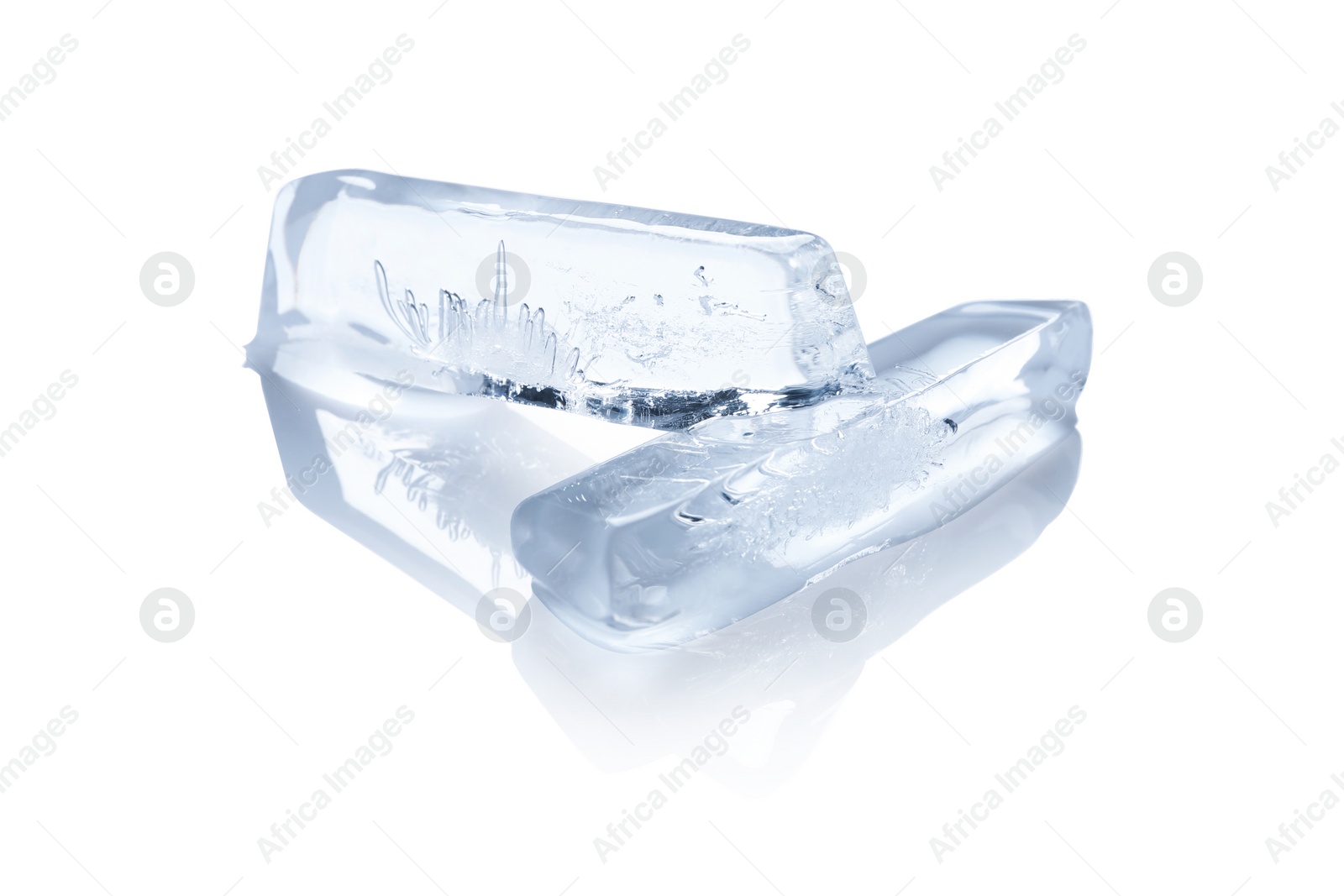 Photo of Pieces of ice melting on white background