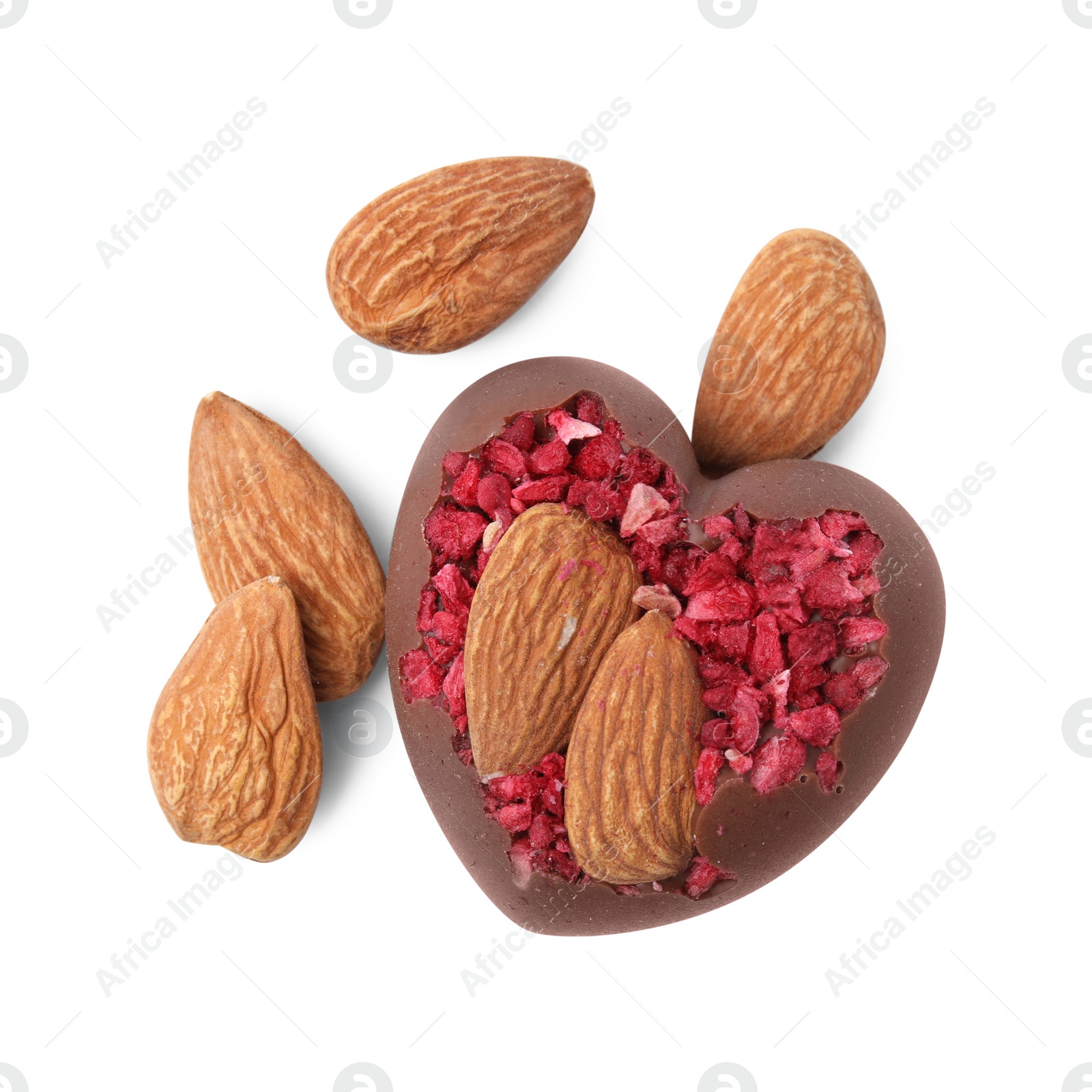 Photo of Tasty chocolate heart shaped candy with nuts on white background, top view