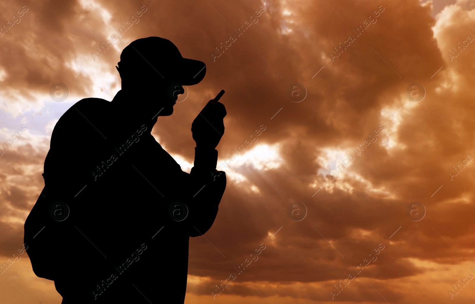 Photo of Soldier with portable radio transmitter outdoors. Military service