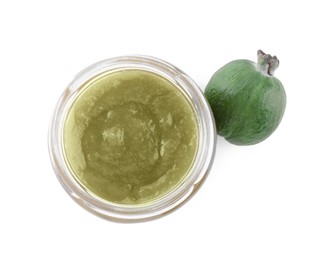 Feijoa jam in glass jar and fresh fruit on white background, top view