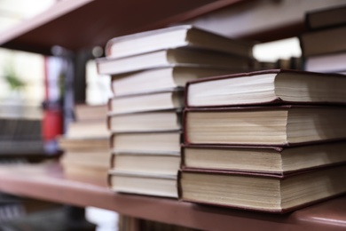 Photo of Stacks of books on shelf in library