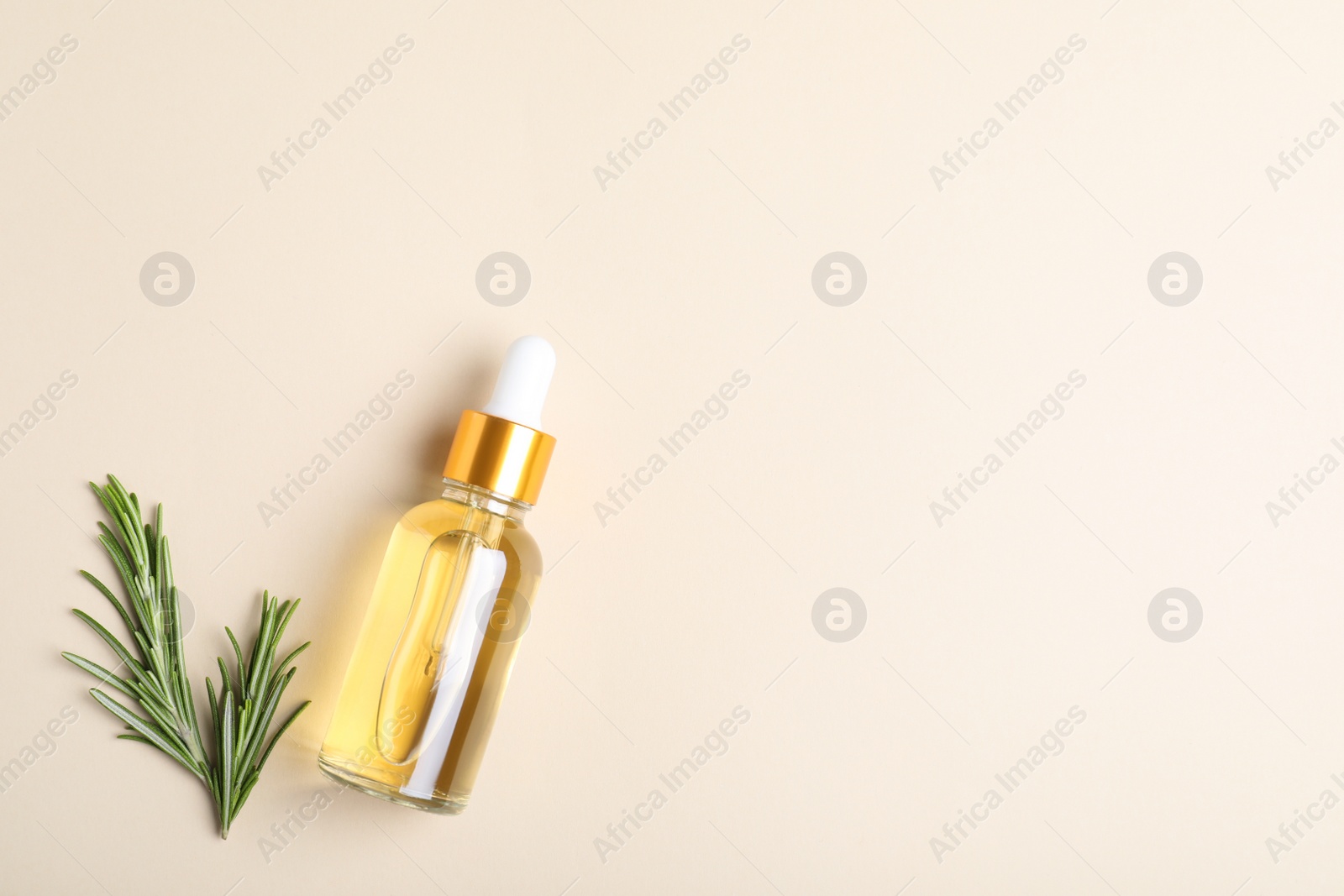 Photo of Flat lay composition with rosemary essential oil and space for text on beige background