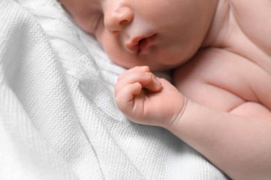 Photo of Small cute newborn baby sleeping on white blanket, closeup