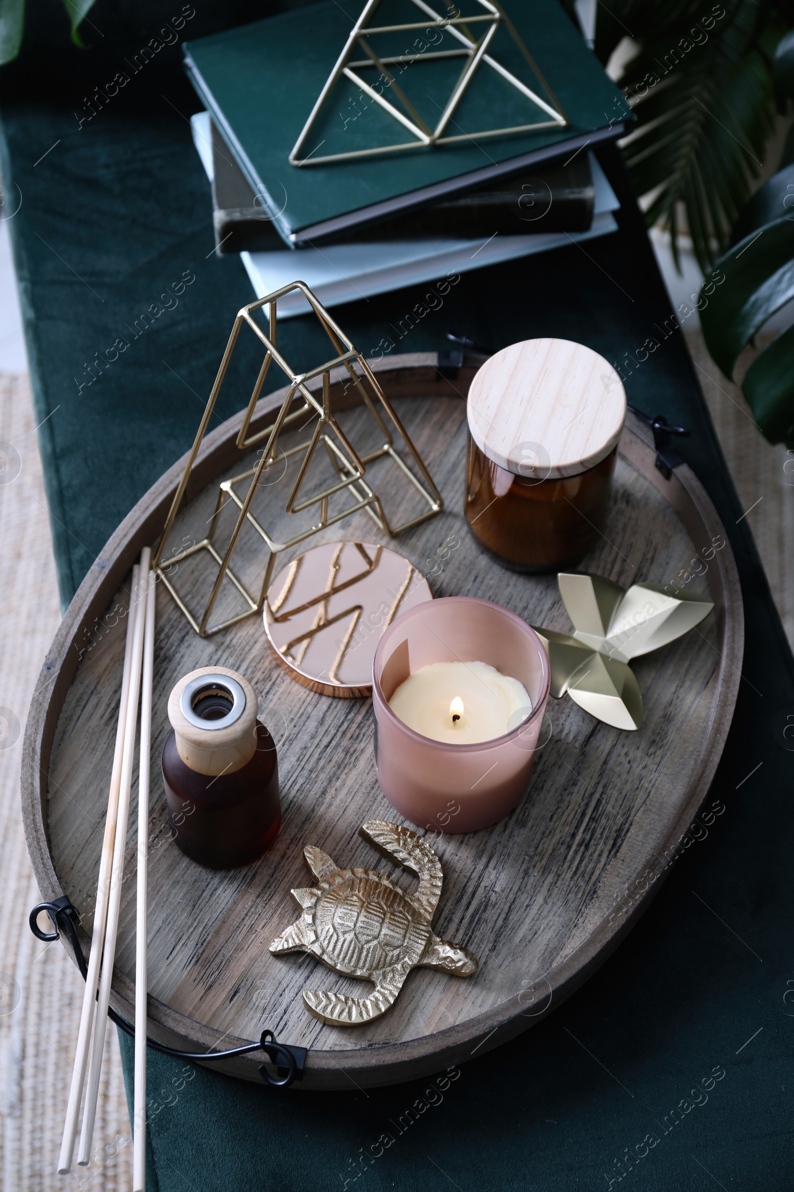 Photo of Wooden tray with decorations on bench indoors