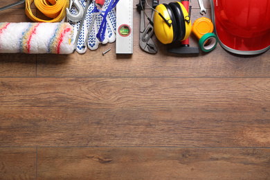 Photo of Flat lay composition with different construction tools and space for text on wooden background