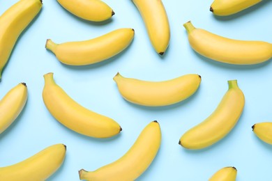 Sweet ripe baby bananas on turquoise background, flat lay