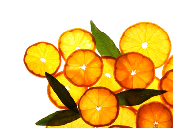 Photo of Slices of fresh ripe tangerines and leaves isolated on white, top view. Citrus fruit